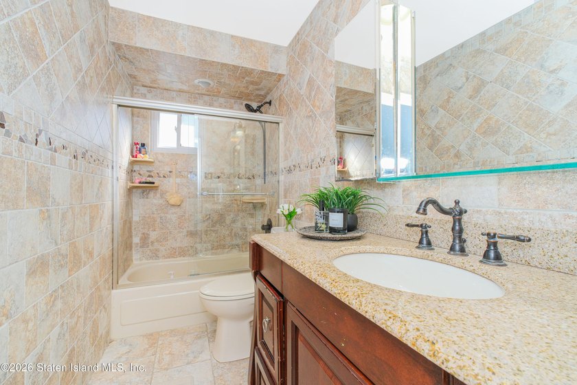 Welcome to 191 Suffolk Avenue, a warm and inviting two-family - photo 9