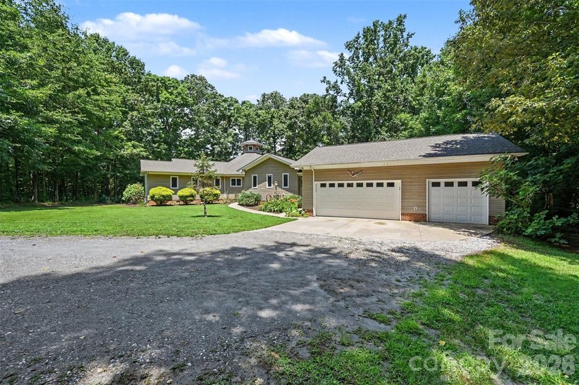Tucked away on over 4 private wooded acres in the desirable - photo 2