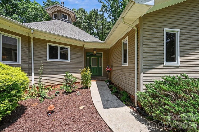 Tucked away on over 4 private wooded acres in the desirable - photo 4