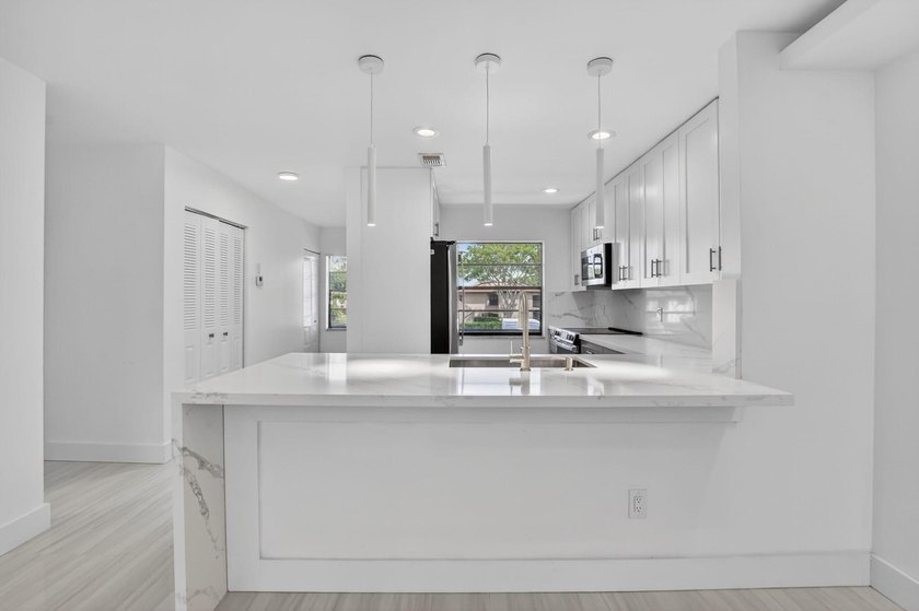 ABSOLUTELY STUNNING FULLY RENOVATED CONDO | BOCA LAGO COMMUNITY - photo 11