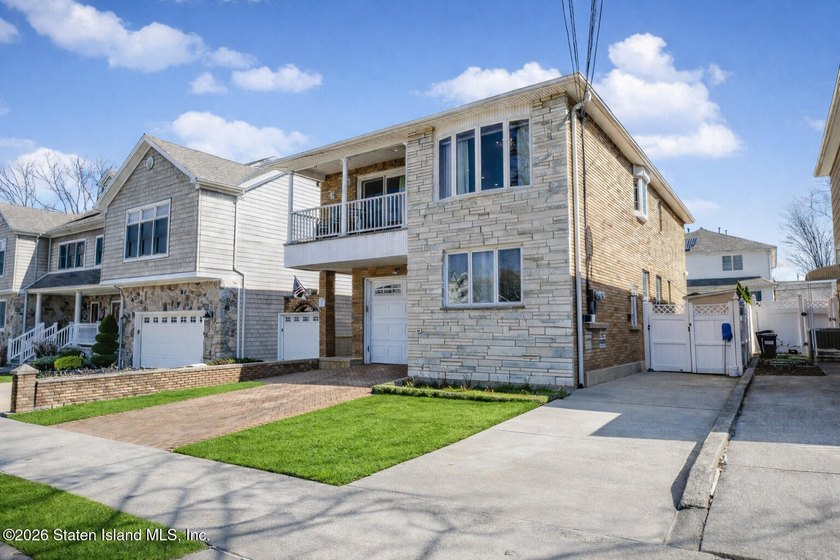 Welcome to this custom-built two-family detached home! This - photo 2