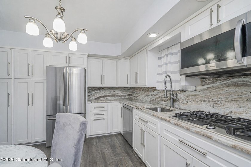 Welcome to 25 Morgan Lane, a charming brick home located in the - photo 6