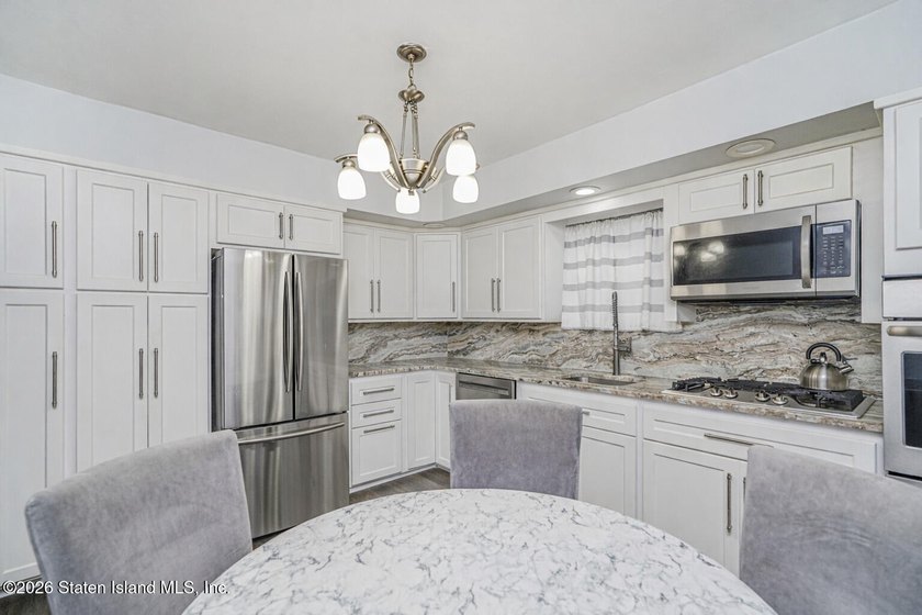 Welcome to 25 Morgan Lane, a charming brick home located in the - photo 7