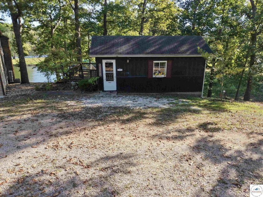 Discover the potential of this quaint two-bedroom cabin, nestled - photo 2