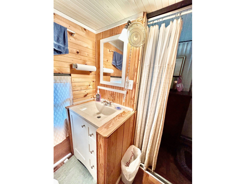 This mobile home is located in a peaceful 55+ community and - photo 11