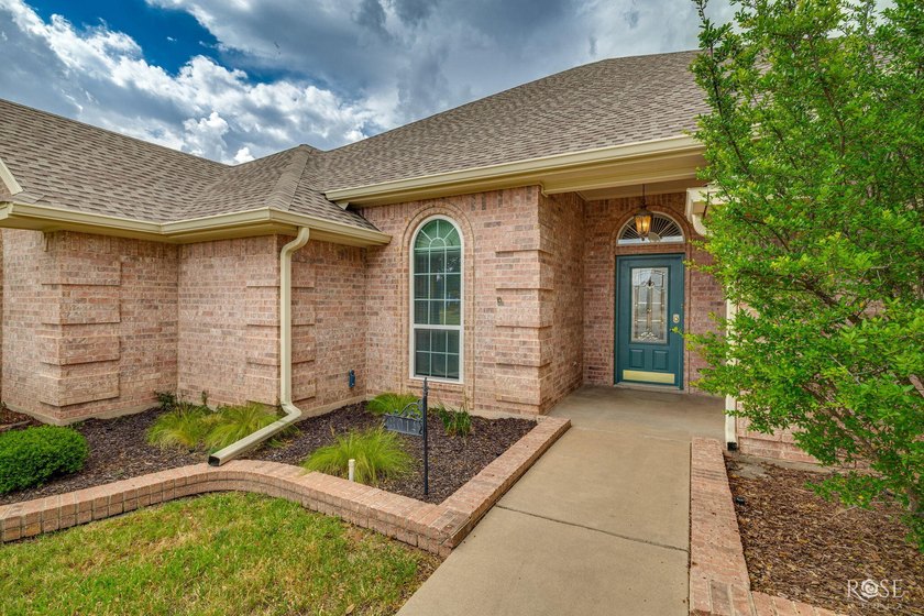 This beautiful, 4-bedroom brick home offers numerous updates and - photo 2