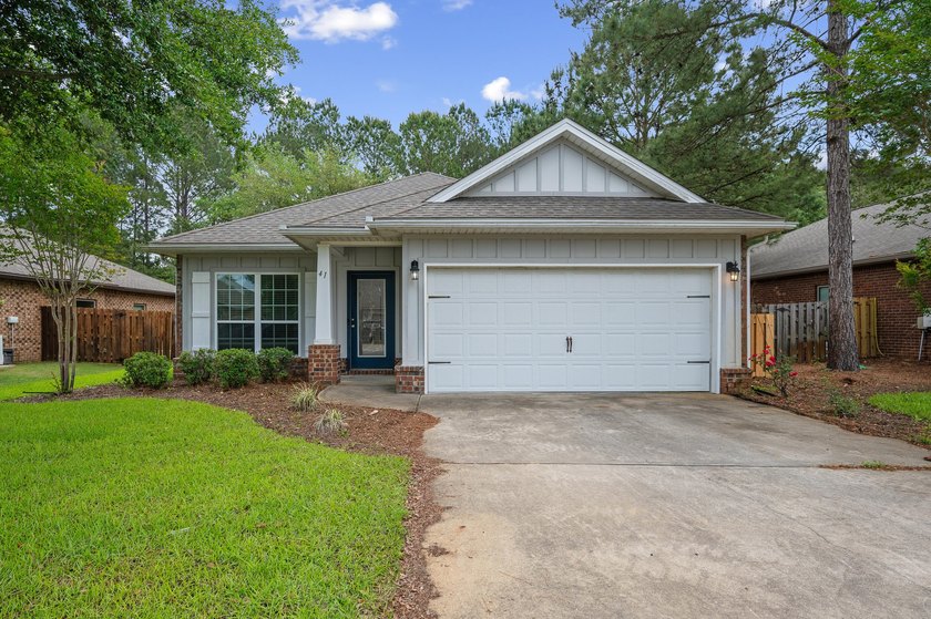 Newer LVP flooring flows through this open-concept Hammock Bay - photo 3