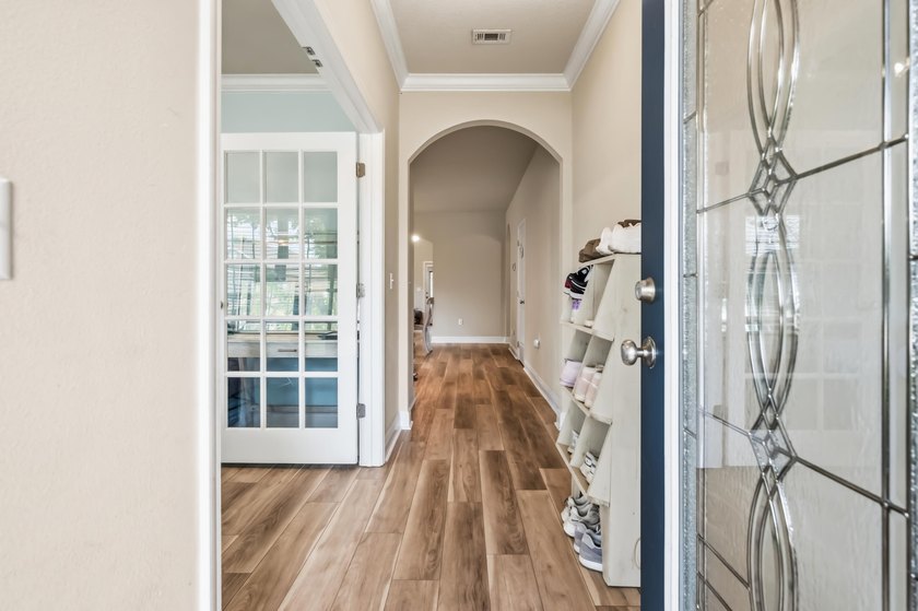 Newer LVP flooring flows through this open-concept Hammock Bay - photo 5