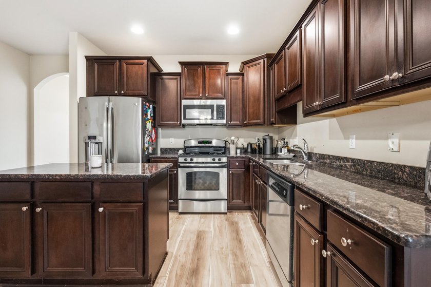 Newer LVP flooring flows through this open-concept Hammock Bay - photo 9