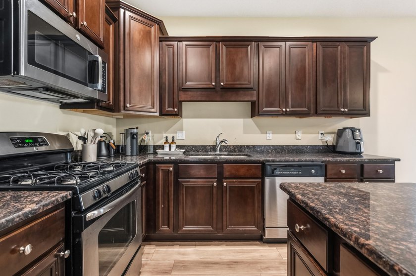 Newer LVP flooring flows through this open-concept Hammock Bay - photo 10