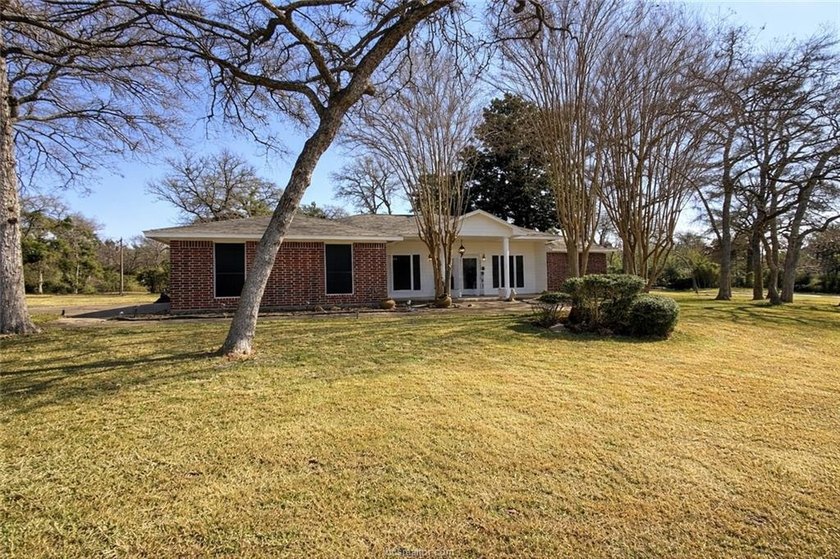 Situated on nearly three-quarters of an acre beneath mature - photo 3