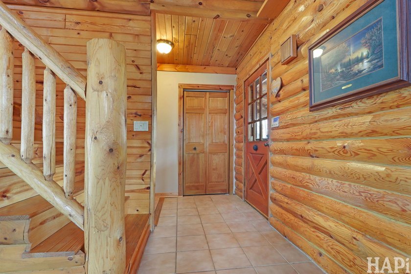 Welcome to this beautiful waterfront log home tucked away on a - photo 4