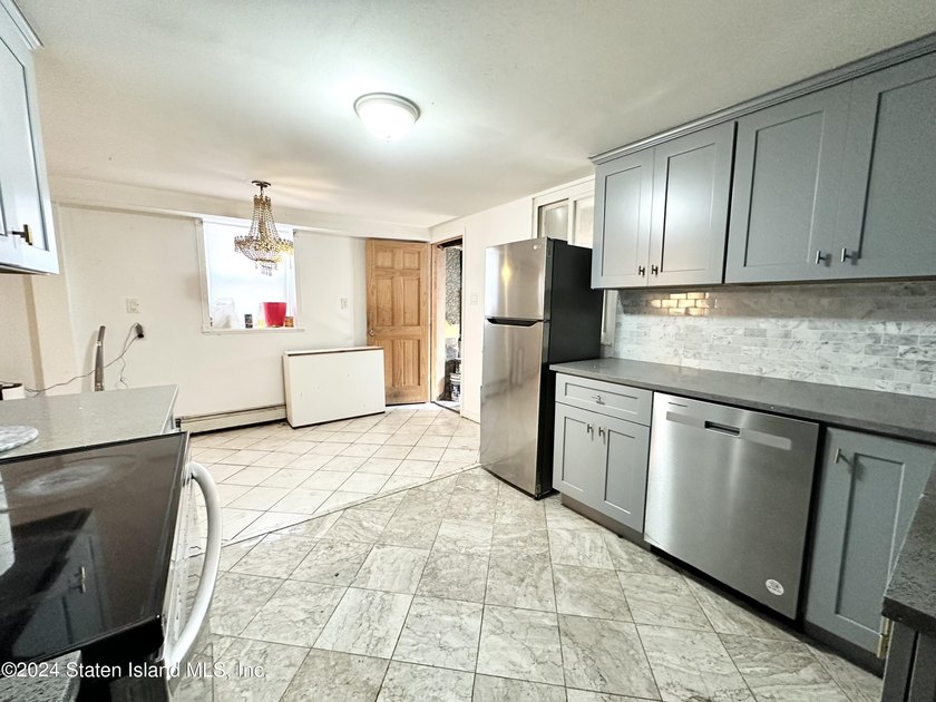 Welcome to this charming two-family detached home located in the - photo 4