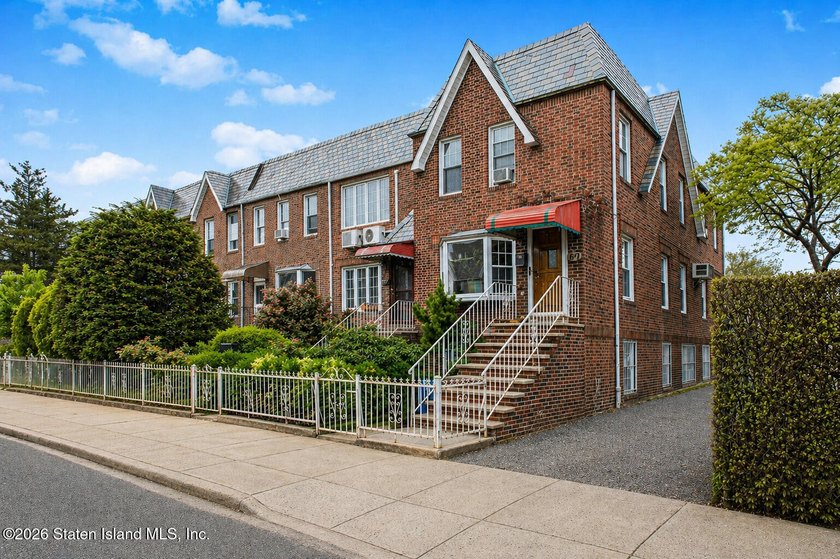 Located at 1879 Haring Street, this full brick end-unit - photo 3