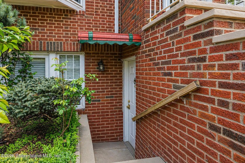 Located at 1879 Haring Street, this full brick end-unit - photo 5