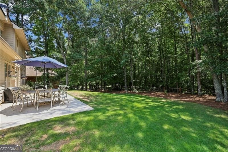Welcome home to 6930 Olde Atlanta Parkway, where refined living - photo 2