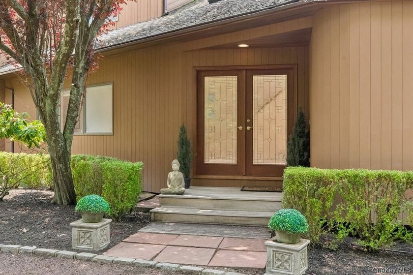 Tucked away on 1.4 acres of lush, landscaped grounds, this - photo 3