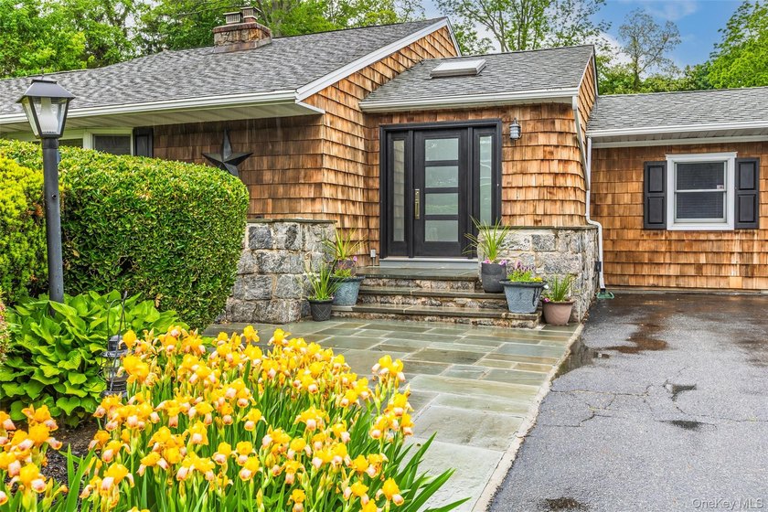 Tucked away on a lush, private three-quarter acre in the highly - photo 2