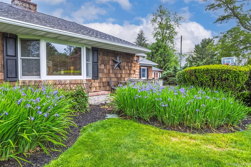 Tucked away on a lush, private three-quarter acre in the highly - photo 3