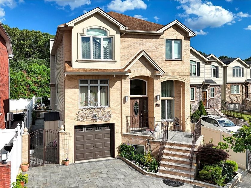 Built in 2013, this detached two-family home with brick front - photo 3