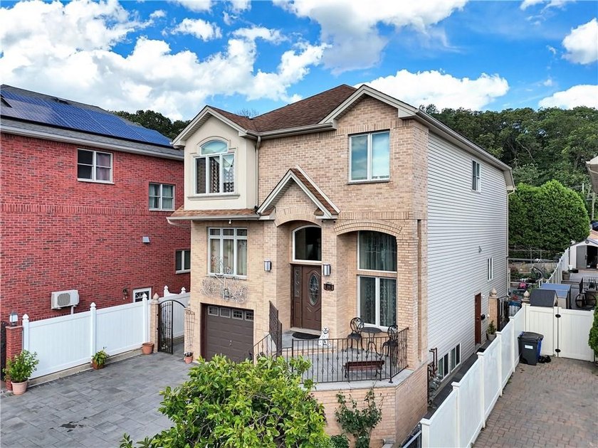 Built in 2013, this detached two-family home with brick front - photo 5