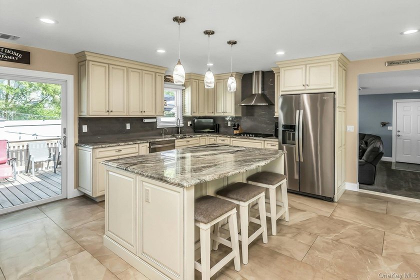 Expanded home featuring a gourmet eat-in kitchen with center - photo 8
