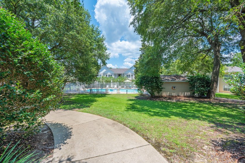 This charming first-floor 2-bedroom, 2-bath condo overlooks the - photo 3