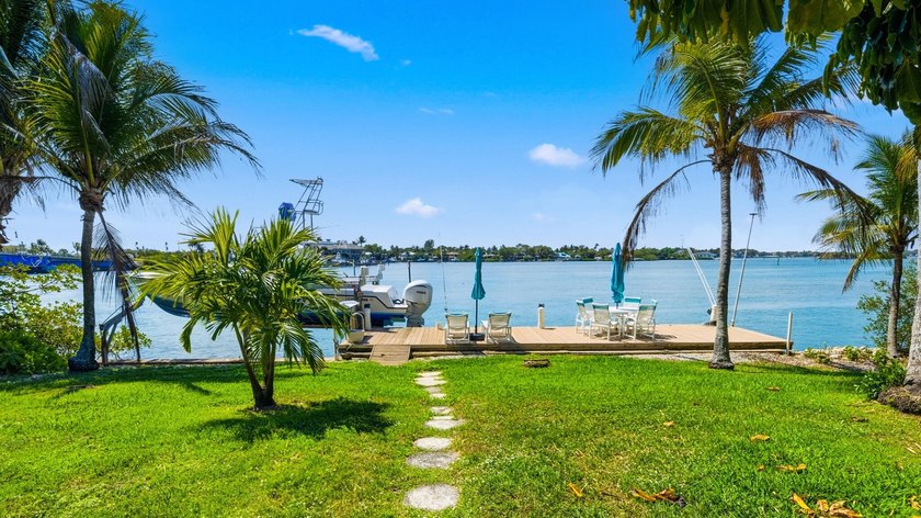 Discover Your Hidden Paradise! This charming riverfront property - photo 2