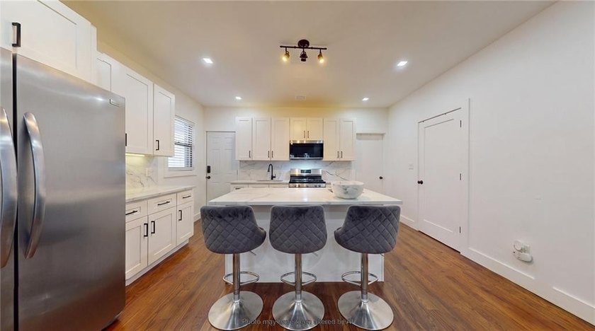 Fully renovated in 2020, this detached single-family home offers - photo 7