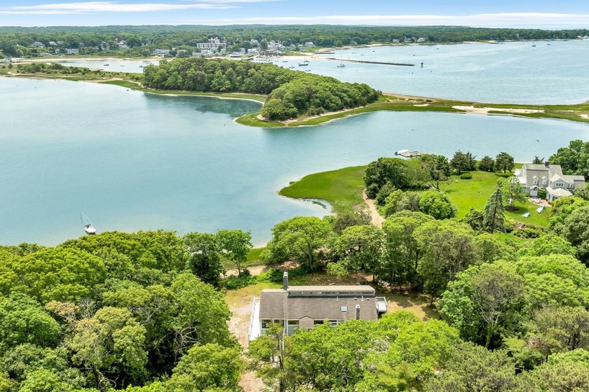 Set on over 3 private acres along the protected shores of - photo 2