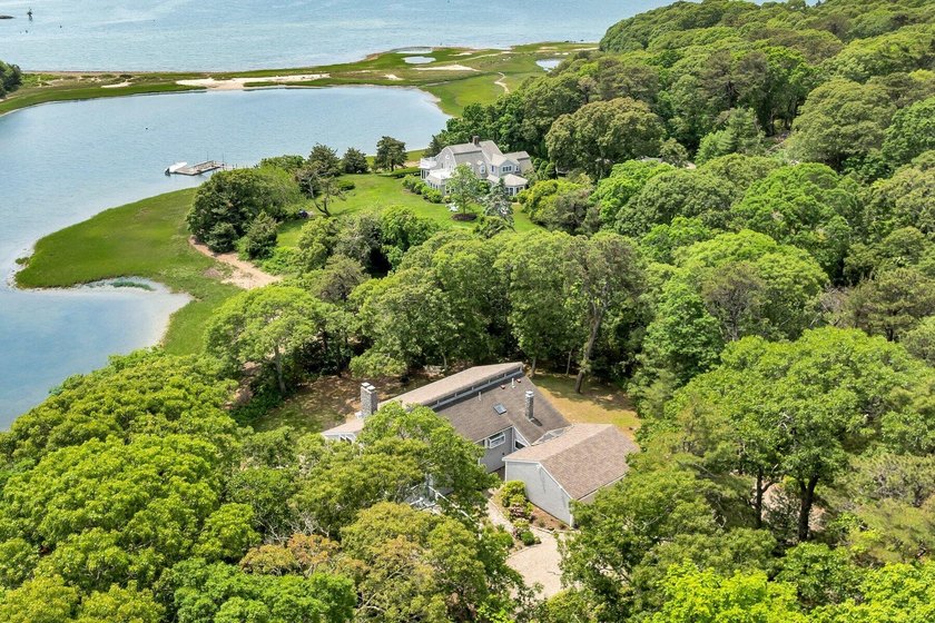 Set on over 3 private acres along the protected shores of - photo 4