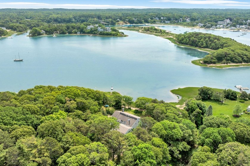 Set on over 3 private acres along the protected shores of - photo 5