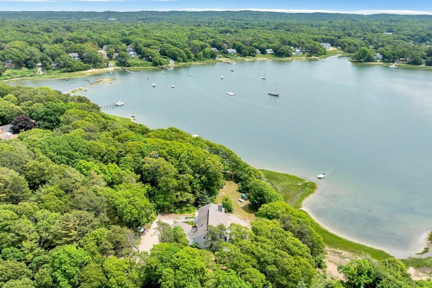 Set on over 3 private acres along the protected shores of - photo 6