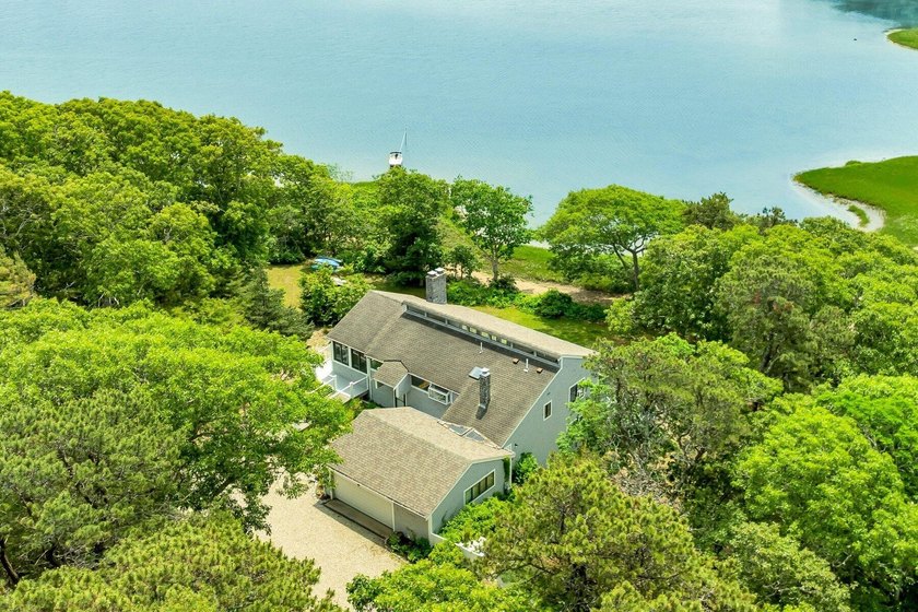 Set on over 3 private acres along the protected shores of - photo 8