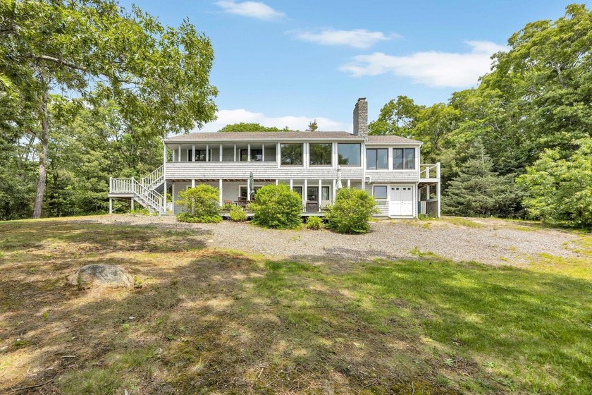 Set on over 3 private acres along the protected shores of - photo 10