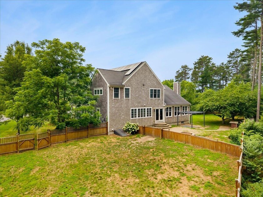 Overlooking Tihonet Pond, 22 Red Pine Lane offers a distinctive - photo 3