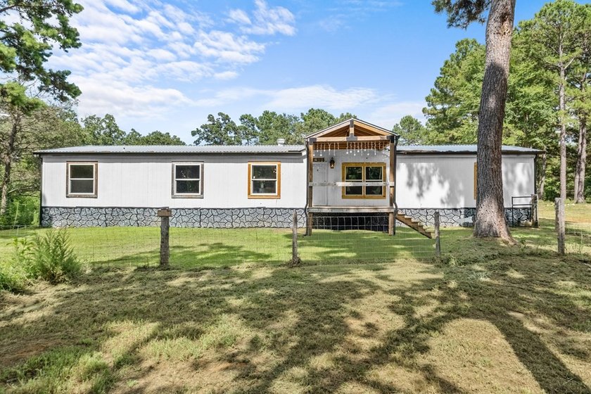 Tucked away among nearly 39 acres of towering timber, this East - photo 2