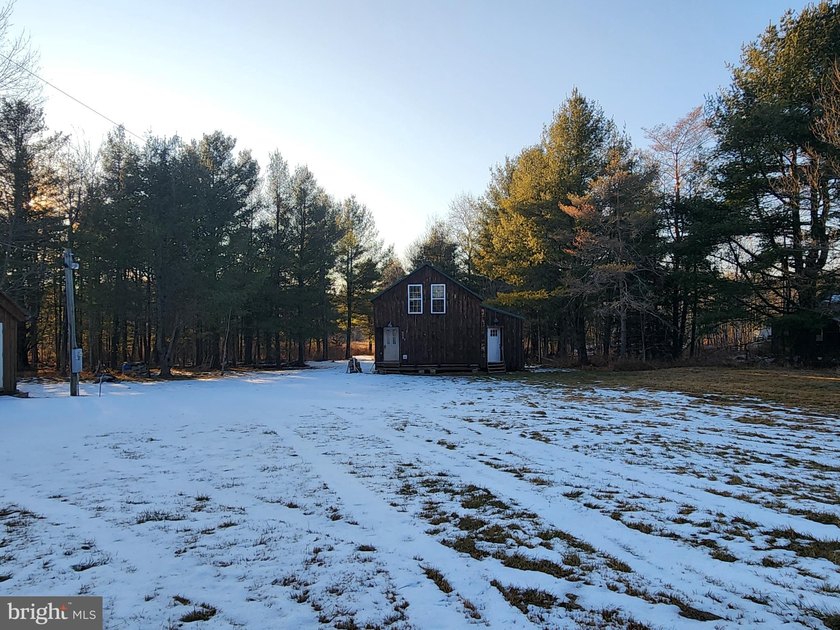 Recreational use wood frame cabin with detached garage and pond - photo 20