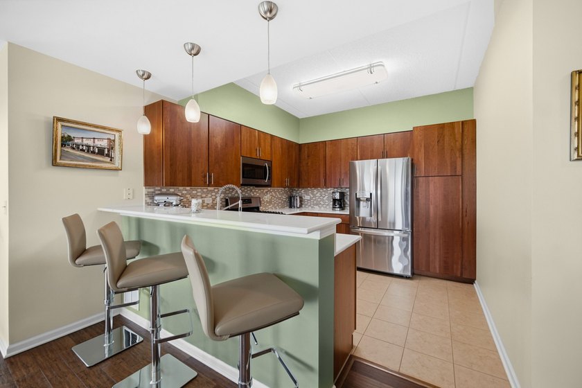 This move-in-ready luxury condo offers the perfect blend of - photo 3