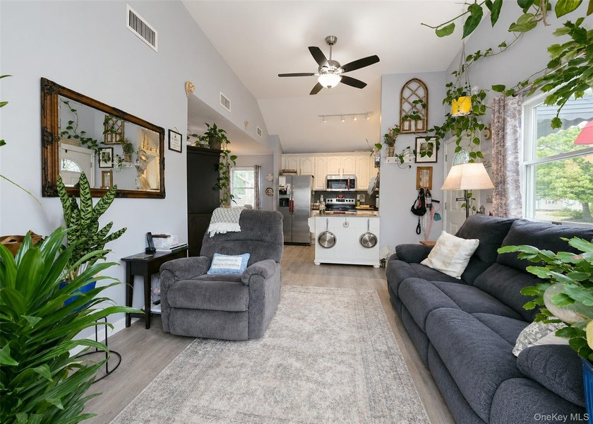 Spacious and open floor plan with cathedral ceilings welcome you - photo 4