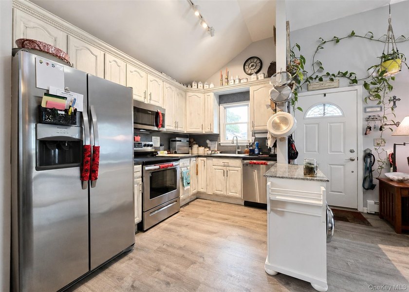Spacious and open floor plan with cathedral ceilings welcome you - photo 5