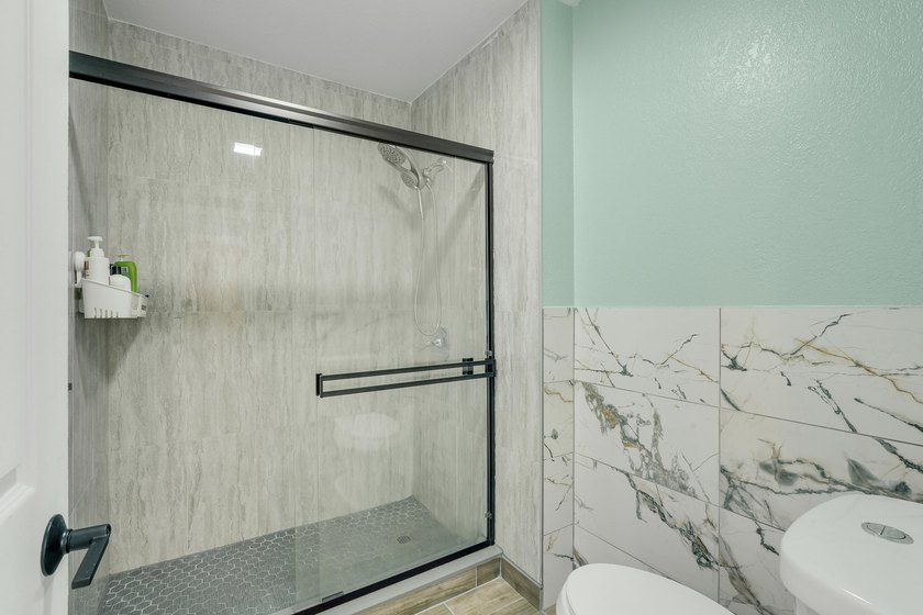 This stunning two-story residence has been completely remodeled - photo 21