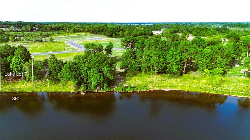 Build your new lake home on this beautifully wooded west-facing - photo 2