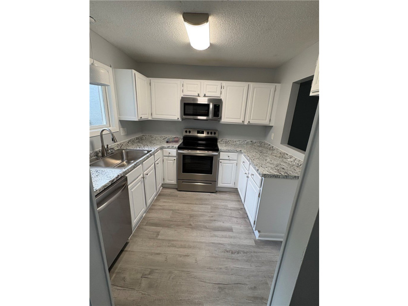 Discover a beautifully remodeled condominium offering a tranquil - photo 3