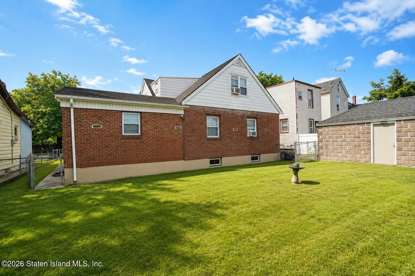 A detached two family home set on an expansive, street to street - photo 3