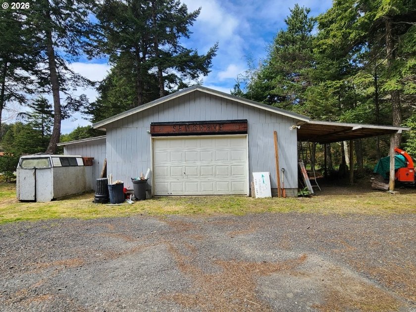 Tucked away among the trees on 1.16 private acres with a Large - photo 2