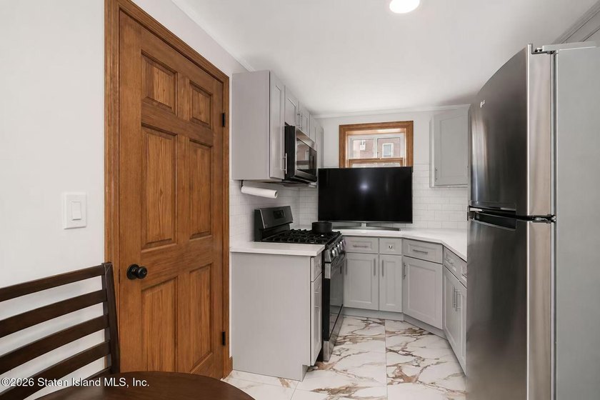 This is a beautifully renovated semi-attached brick - photo 10