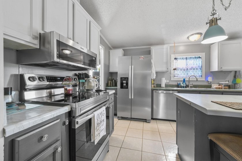 Welcome to 6043 East West Way, an inviting coastal home nestled - photo 2