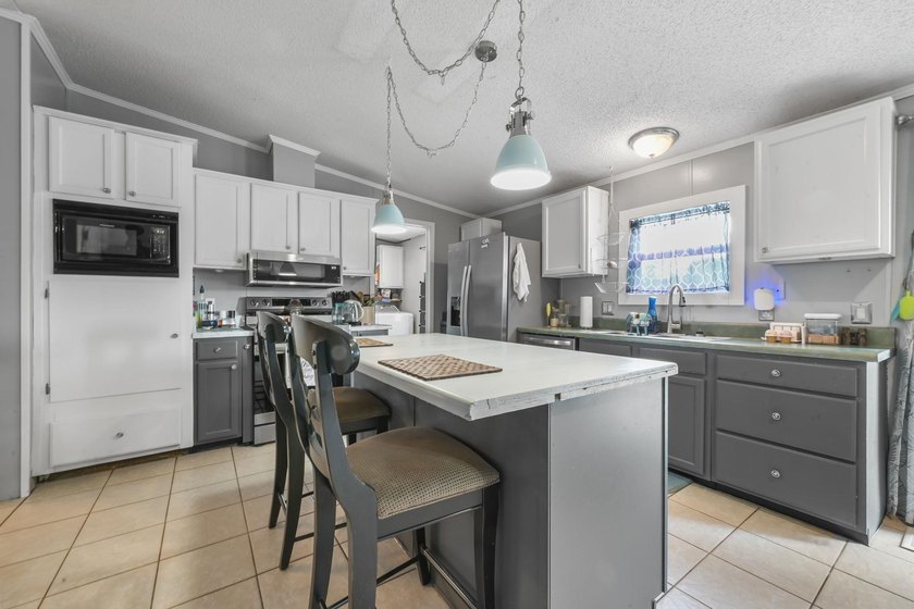 Welcome to 6043 East West Way, an inviting coastal home nestled - photo 3