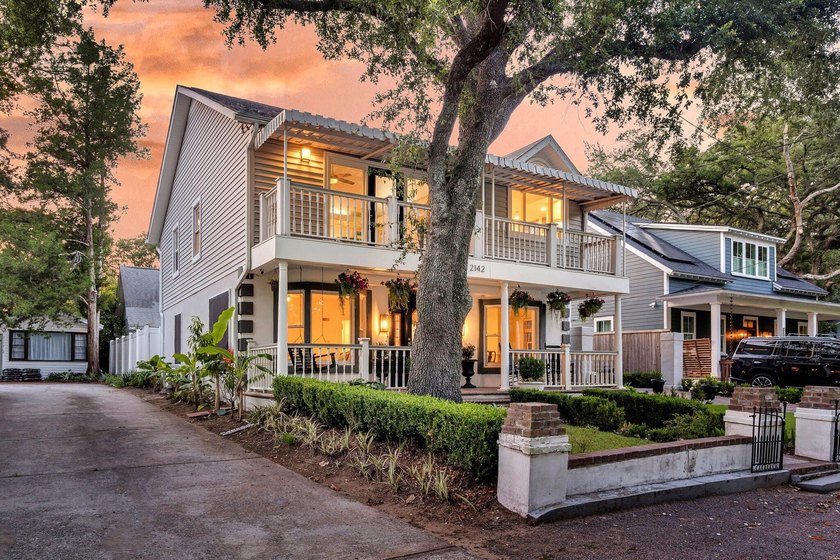 Tucked beneath a canopy of sweeping live oaks, this beautifully - photo 3